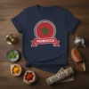 Navy blue t-shirt featuring the Morocco flag design with a red circle, green pentagram, and "MOROCCO" banner