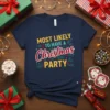 Navy blue t-shirt with the text "MOST LIKELY TO HAVE A Christmas PARTY" in yellow and red, surrounded by festive