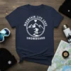 Mountain Life Love Snowboard text with graphic of mountains and snowboarder on navy t-shirt