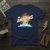 Navy blue t-shirt with "MR. AMAZING" text in bold white and red, featuring a flying superhero over a city skyline