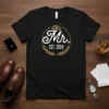 Mr. EST. 2024 wedding t-shirt design with wedding rings and laurel wreath