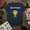 Mr. Tattoos graphic tee featuring a character covered in colorful tattoos and the text MR. TATTOOS