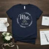 Mrs. Est. 2026 t-shirt with wedding rings and floral wreath design, navy blue