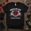 Muscle of Love Guarding My Heartbeat t-shirt design featuring strong muscular arms holding a red heart