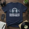 Music Is My Heartbeat quote on a navy t-shirt with headphones and city skyline graphic