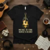 Black t-shirt with "Music Is The Soul's Echo" text and a golden guitar graphic with a castle and moon scene