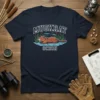 Navy t-shirt featuring the "MUSKRAT OCEAN" text above a muskrat swimming in water with cattails