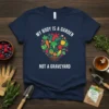 T-shirt with white text "My Body Is A Garden Not A Graveyard" above a heart-shaped arrangement of colorful vegetables and