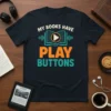 T-shirt with the text "My Books Have Play Buttons" in colorful fonts, featuring an open book graphic with a play