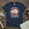 My Cat Walks All Over Me text design with a sleeping cat graphic and pink hearts, on a navy blue