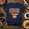 My Emergency Contact Is Bacon t-shirt design featuring bold orange text and a shield with bacon strips and utensils