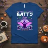 My Family Is A Little Batty Halloween t-shirt design featuring a purple bat, ghosts, pumpkins, and moon graphic