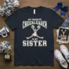 Text "My Favorite Cheerleader Is My Sister" with a graphic of a cheerleader mid-jump, on a navy blue t-shirt