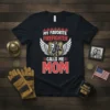 Black t-shirt with "MY FAVORITE FIREFIGHTER CALLS ME MOM" text, firefighter helmet graphic, and wings