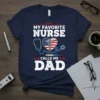 My Favorite Nurse Calls Me Dad T-Shirt featuring patriotic heart with stethoscope and syringe graphic