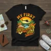 My First Helicopter Ride text with helicopter graphic, tropical flowers, and sunset landscape on a black t-shirt