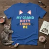 Blue t-shirt with "MY GRAND KITTY LOVES ME" in colorful text and cat ears graphic, perfect for cat grandmas