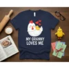 My Granny Loves Me text with a cute chicken and chick graphic on a navy t-shirt