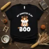 Black t-shirt with white text "my hamster IS my BOO" and a cute cartoon hamster wearing a witch hat, holding