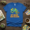 Blue t-shirt with a colorful cartoon chameleon and the text "My Heart Has Scales"