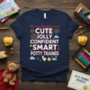 Toddler t-shirt with text "My Mum Describes Me As CUTE JOLLY CONFIDENT SMART POTTY TRAINED" and playful graphics including stars