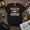Black t-shirt with "CAUTION! MY NOISE CAN CAUSE CANCER" text and wind turbine graphic