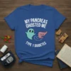 Blue t-shirt with white text "MY PANCREAS GHOSTED ME TYPE 1 DIABETES" and cartoon ghost and pancreas graphics