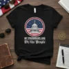 Black t-shirt with "MY PRONORUNS ARE We/the/People" text and a circular graphic of the US Capitol building with American flag