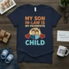 My Son-In-Law Is My Favorite Child t-shirt featuring cartoon illustration of two men and a baby with hearts