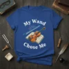 My Wand Chose Me text with a violin and sheet music graphic on a blue t-shirt