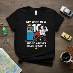 T-shirt design with text "My Wife Is A 10 And So Are Her Miles To Empty", featuring a superhero woman