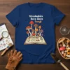Mycologists have more Fungi text on a navy t-shirt with a mushroom illustration growing from an open book