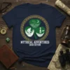 Mythical Adventures Irish Edition T-Shirt design with Bigfoot, Loch Ness Monster, and alien in a shamrock, on a navy shirt