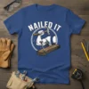 Nailed It text with illustration of muscular arm hammering a nail into wood, on a blue t-shirt