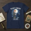 Nancy Drew And The Hidden Staircase T-Shirt featuring the detective with a magnifying glass and a haunted mansion graphic