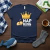 Nap King t-shirt design featuring a sleeping lion wearing a crown next to bold text "NAP KING" and a large