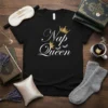 Nap Queen t-shirt with white script text and gold crowns, designed for sleep lovers