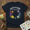 Native Blooms Flora & Botany Collection T-Shirt featuring a wreath of colorful wildflowers and a bee graphic with text "Native