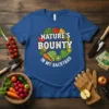 Nature's Bounty In My Backyard t-shirt design featuring a circular arrangement of fresh vegetables and fruits with bold white text