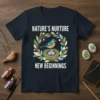 Nature's Nurture New Beginnings t-shirt with a bird in a nest and three eggs, surrounded by a floral wreath