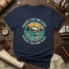 Navy t-shirt with "Navigate Your Own Course" text around a ship's wheel, lighthouse, and sailboat graphic