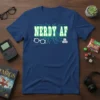 Nerdy AF T-Shirt with circuit board, glasses, and dice graphics in green and white on a navy blue shirt