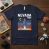 Nevada 1969 rocket launch graphic on a navy blue t-shirt, featuring a retro space theme with mountains and a crescent