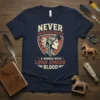 Never Underestimate A Woman With Lipan Apache Blood text on a navy t-shirt with shield graphic of a Native American