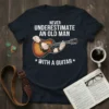 Never Underestimate An Old Man With A Guitar T-Shirt design featuring a man playing an acoustic guitar, white text on