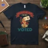 Nevertheless She Voted t-shirt design featuring a hand holding a ballot with a red X, surrounded by flowers