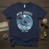 New Jersey Est 1664 t-shirt design with swirling ocean waves, clouds, sun, and a skull graphic