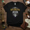 Black t-shirt with "New Orleans Louisiana" text, streetcar graphic, and musical instruments, inspired by Mardi Gras