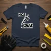 NICE CAULK text with a caulk gun graphic on a navy blue t-shirt, suitable for construction humor