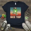 Retro NICE TRIP t-shirt design with a cartoon frog skateboarding against a sunset graphic
